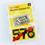 Teenbeat enamel pin with backing card inside plasticine envelope