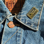 Teenbeat enamel pin, again, on a denim jacket